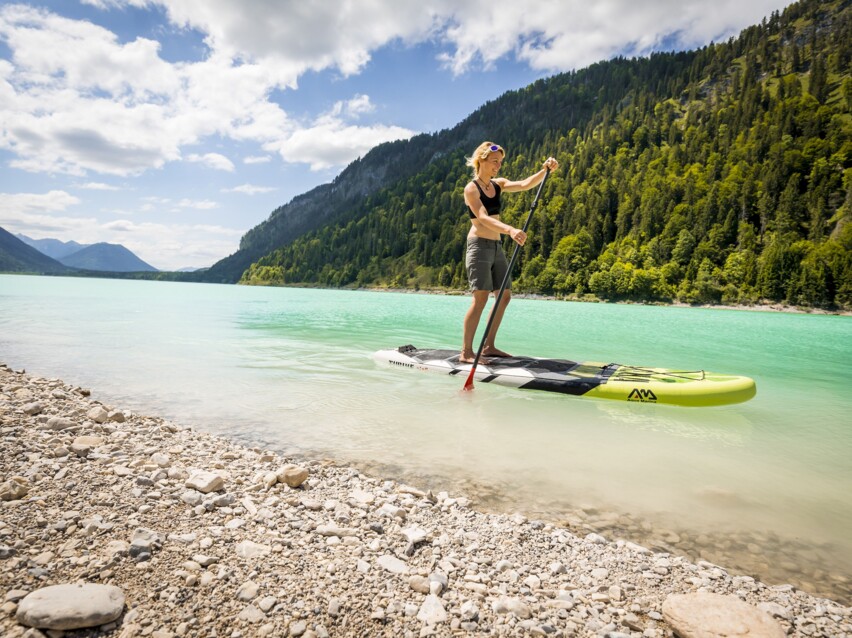 Frau auf einem Stand up Paddle am Sylvensteinsee