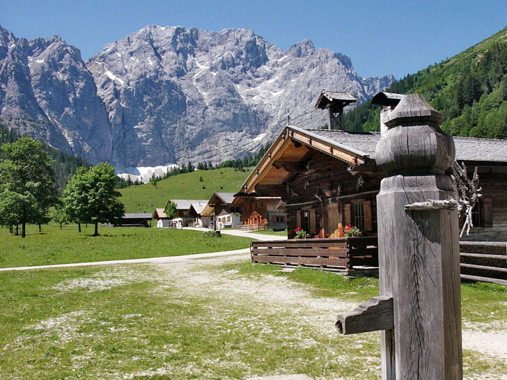 Ein Brunnen und Almen unterhalb der Karwendel-Gipfel